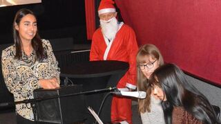 Janine Marielle Ruch (v. l.) und der Nikolaus begutachten, wie Paula Widenka und Amelie Rahel Ruch bei „Feliz Navidad“ in die Tasten hauen.