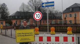 Alexander Mitsch zeigt in Schwetzingen ein Plakat der Werteunion-Aktion.