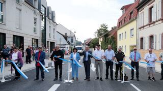 Vertreter der Stadtverwaltung, des Gemeinderats und der am Bau beteiligten Firmen schneiden symbolisch das Band zur Freigabe durch: Martina Braun (v. l.), Haydar Sahin, Professor Josef Walch, Elfriede Fackel-Kretz-Keller, Oberbürgermeister Dr. René Pöltl, Mark Töllner, Armin Keller, Harald Fischer, Joachim Aurisch, Werner Zieger, Adolf Eiling, Michael Grumann und Bürgermeister Matthias Steffan.