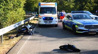 Das Motorrad des Verunglückten liegt an der Leitplanke an der Abfahrt der B 39, Streifenwagen sichern die Unfallstelle.