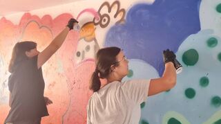 Amelie (l.) und Sozialarbeiterin Lea Giese (r.) legen sich beim Graffitimalen richtig ins Zeug und sorgen so für einen echten Hingucker in der Unterführung bei der Wormser Straße.