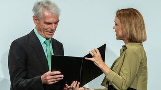 Petra Olschowski, Staatssekretärin im Ministerium für Wissenschaft, Forschung und Kunst, übergibt die Urkunde zur Heimatmedaille Baden-Württemberg an Dr. Volker Kronemayer, den Vorsitzenden des Heimatvereins Brühl.