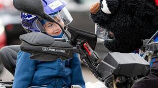 Der kleine Eduard Incau darf auf einem Trike mitfahren.