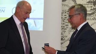 Landrat Stefan Dallinger (r.) überreicht Rüdiger Burger den Ehrenring.