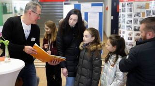 Eltern erhalten mit ihren Kindern Informationen aus erster Hand – zum Beispiel über das Angebot, Gitarre zu lernen.