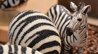 Mit Glasperlen ist hier das Muster eines Zebras nachempfunden. Fein säuberlich sind diese aneinandergereiht.