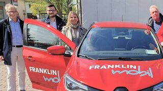 Berater Thomas Kobler (v. l.), die Franklin-Geschäftsführer Vinzent Grimmel und Gabriele Teltz, Ortsbaumeister Reiner Haas, Bürgermeister Dr. Ralf Göck und Anna-Lena Schneider, die beim Personalamt die Verwaltung des Dienstwagens übernommen hat, vor der ersten Probefahrt mit dem roten E-Renault.