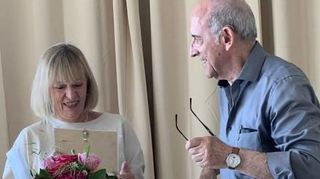 Franz Hauns übergibt Siglinde Biok Blumen und eine Urkunde.