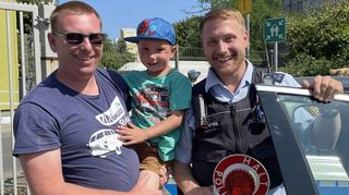 In der Polizeiuniform verbirgt sich Spitzengewichtheber Jürgen Spieß (r.). Er erläutert Ben und Vater Sven Bitz die Ausstattung eines Streifenwagens.