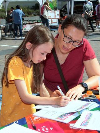 Leah und Elena Heidenreich lösen ein Quiz der Tauschring-Agendagruppe.
