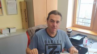 Sebastian Längerer präsentiert in seinem Büro Plakate für zwei anstehende Projekte: links die Ankündigung für das „Jugend-Hearing“ mit QR-Code für die Umfrage, rechts das Street-Art-Projekt auf dem Gelände von Edeka Embach.