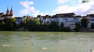 Die Basler Altstadt bietet für die Schwimmer im Rhein eine spannende Kulisse.