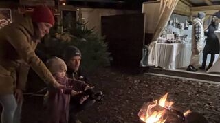 Melanie und Daniel Wehner aus Ketsch wärmen sich mit ihrer kleinen Lea am Feuer, das im Außenbereich für die passende Stimmung sorgt.