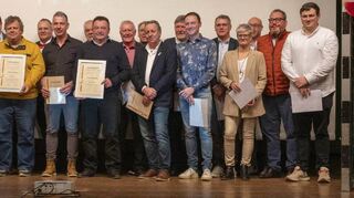 Der Präsident des Badischen Handballverbandes Peter Knapp (links) überreicht viele silberne und goldene Ehrennadeln sowie drei Ehrenbriefe an engagierte TBG-Vereinsmitglieder.