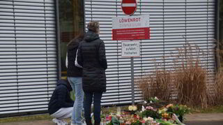 Vor dem Löwenrot-Gymnasium haben Menschen Blumen und Kerzen im Gedenken an die getötete Schülerin abgelegt.