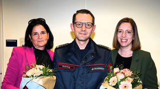 Kommandant Lars Oehring, im Ordnungsamt für den Bereich Feuerwehr, Bevöl-kerungshilfe und kommunale Gefahrenabwehr zuständig, überreicht Blumen an Ordnungsamtsleiterin Yvonn Rogowski (l.) und Stellvertreterin Miriam Knapp.