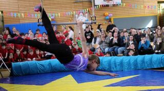 Wie in einem echten Zirkus hängt das Mädchen bei der Vorführung in der Jahnhalle am Trapez und zeigt beeindruckende Kunststücke.