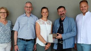 Freude über eine weitere Plakette für die Hartmann-Baumann-Schule: Karin Böning (Hochbauabteilung, v. l.), Schulleiter Marcus Roth, Hochbauabteilungsleiterin Katrin Pfisterer, Architekt Michael Jöllenbeck mit der Auszeichnung und sein Kollege Max Schüßler. Schon 2023 wurde das Projekt beim Hugo-Häring-Preis prämiert.