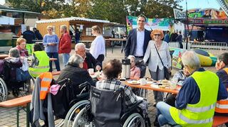 Bürgermeister Kevin Weirether und Jutta Singer vom Haus Edelberg im Kreis der Senioren, die traditionell zur Kerwe eingeladen werden.